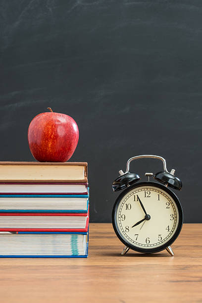 istock red apple and alarm clock, school desk, back to school 612266622