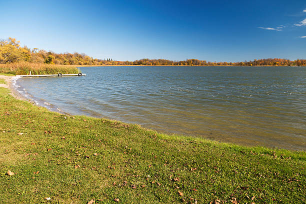 istock Autumn in Minnesota - Green Grassy Lakeshore 612267146
