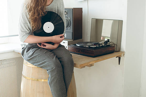 istock girl  keep the vinyl disk on hands. 612270282