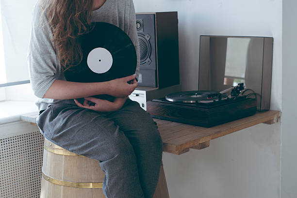istock girl  keep the vinyl disk on hands. 612270296