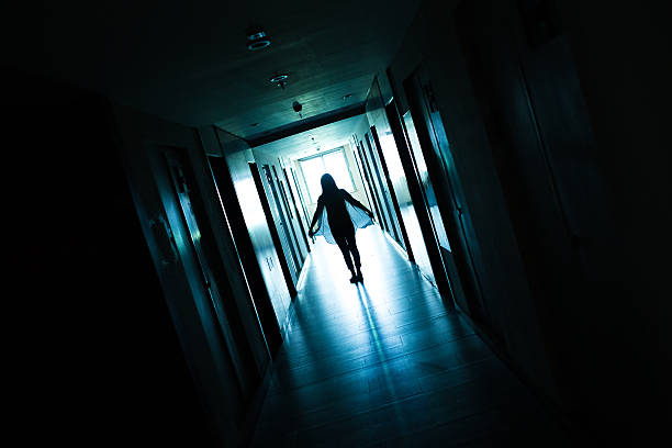 istock Young woman  in dark building walkway 612369256
