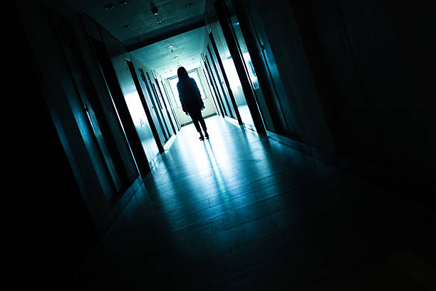 istock Young woman  in dark building walkway 612369296