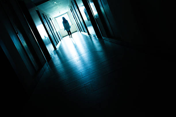 istock Young woman  in dark building walkway 612369382