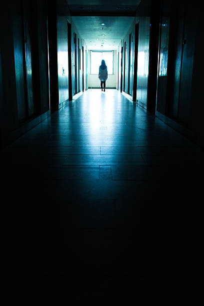 istock Young woman  in dark building walkway 612369436