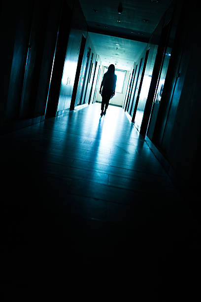 istock Young woman  in dark building walkway 612369490
