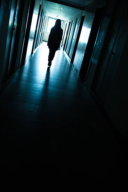 istock Young woman  in dark building walkway 612369542