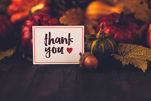 istock Thanksgiving still life background with pumpkins, acorns and message 612370502