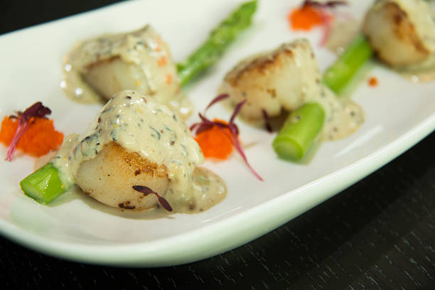istock Scallops with Cava Cream and Herb Sauce. 612371682