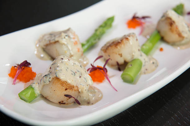 istock Scallops with Cava Cream and Herb Sauce. 612371686