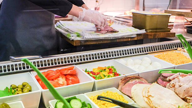 istock Chef preparing lunch meal from salad bar 612372406