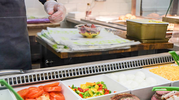 istock Female chef preparing salad bowl 612372444
