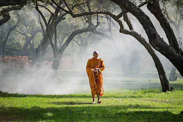 istock Buddhist monk walking to receive food 612373116