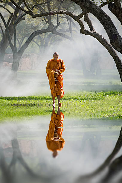 istock Buddhist Monk walking to receive food 612373434