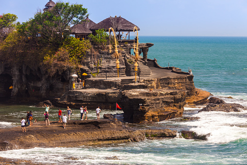 Bali, Indonesia - September 20, 2012: Tourists exploring Pura Tanah Lot in Bali, Indonesia.