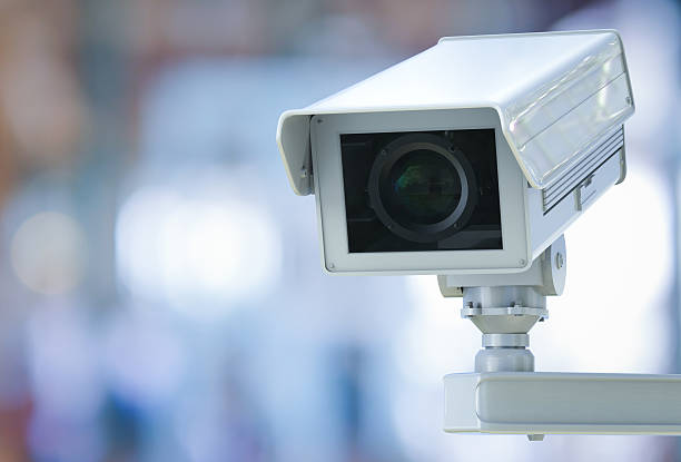 istock cctv camera or security camera on retail shop blurred background 612374770