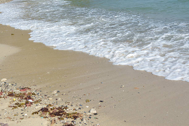 istock Foamy white waves on the beach 612375058