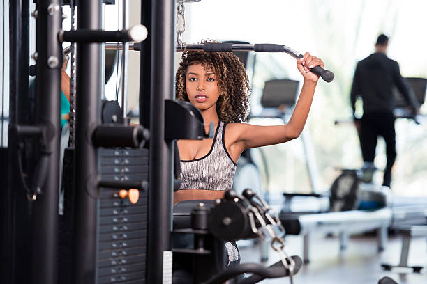 istock Woman doing back exercising at GYM club. 612377016