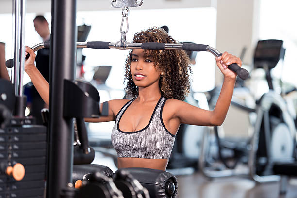 istock Woman weightlifting exercising focuses on training. 612377702