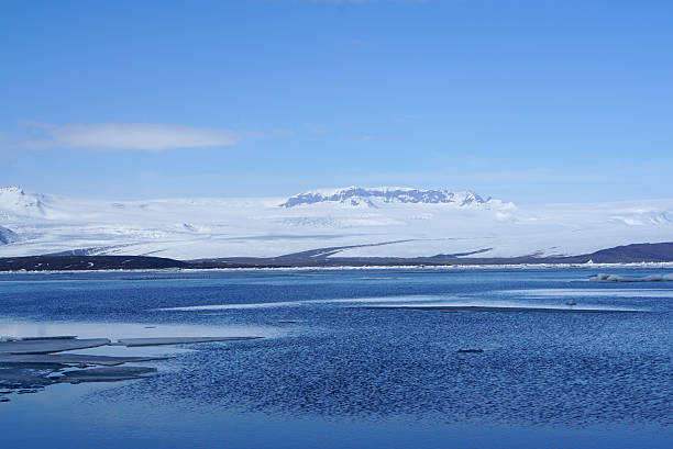 istock ice sheet on the water with snow mountain background 612380482