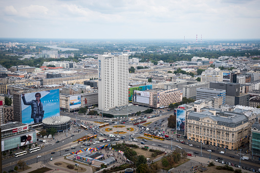 High angle view of central Warsaw, Poland, including billboards, shopping center, and various kinds of transportation (tram, car, bus)