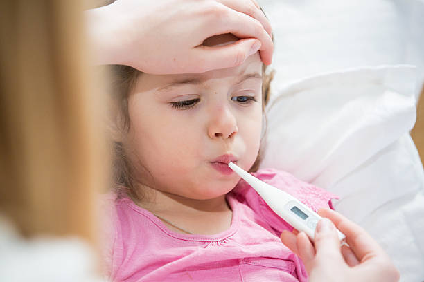 istock Sick child with high fever 612381606