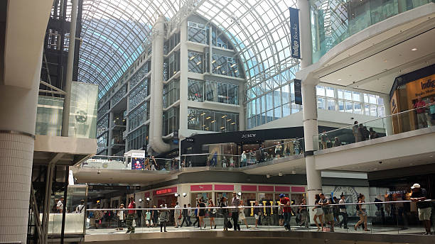 Toronto, Canada - August 10, 2016: Unidentified shoppers in the inside view of the Eaton Centre. A modern shopping mall in Toronto  full of shoppers, shops, restaurant and people as editorial 