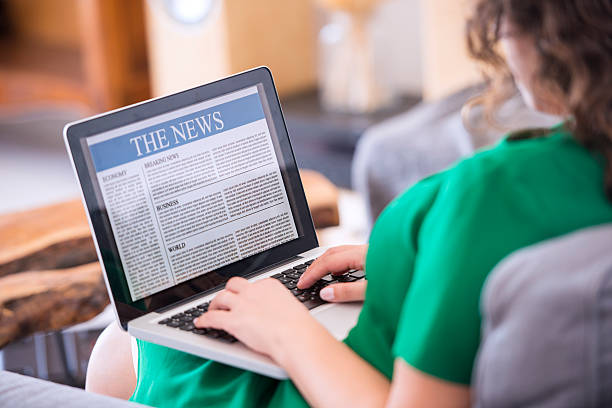 istock Reading news on laptop 612384766