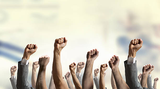 istock Group of people with raised hands . Mixed media 612385056