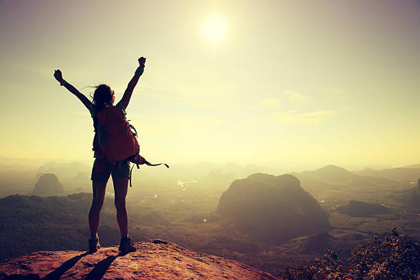 istock young woman backpacker hiking at seaside mountain cliff 612385106