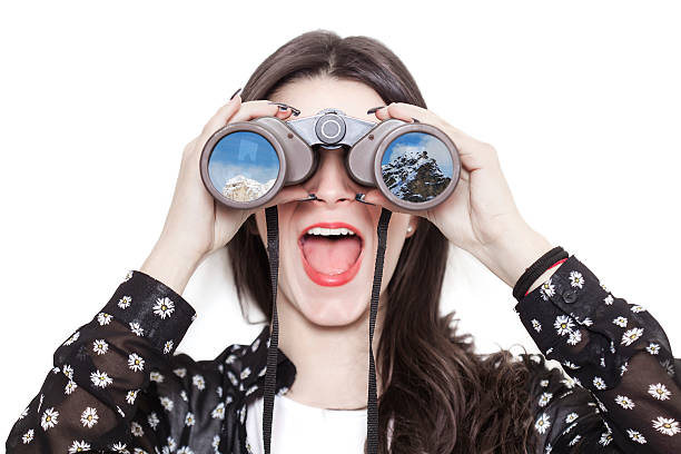 girl portrait looking at mountains through binoculars - olhando através imagens e fotografias de stock