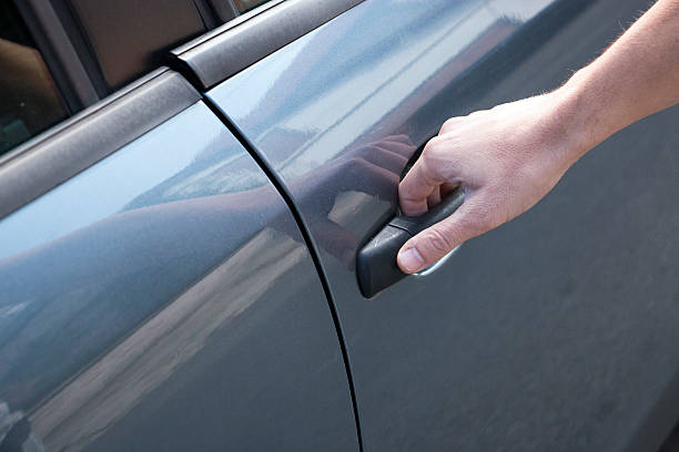 istock Close up human hand opening car door 612386976