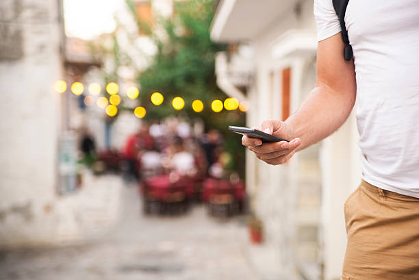 istock Man with smart phone on hand, blurred background 612387202