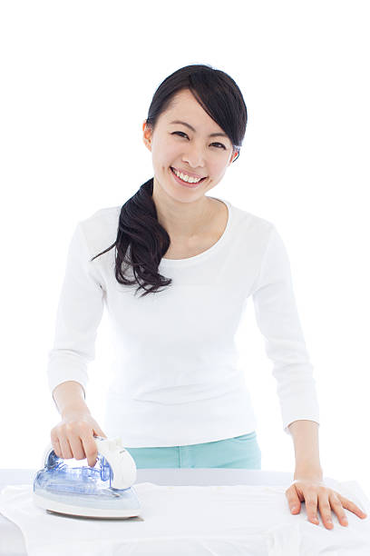 istock Japanese woman using the iron 612387510