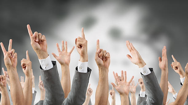 istock Group of people with raised hands . Mixed media 612387540