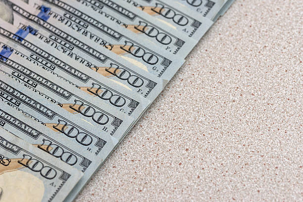 istock us dollar on light wooden table 612388860