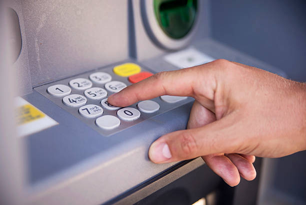 istock Close-up of hand entering PIN/pass code on ATM/bank machine keyp 612388906