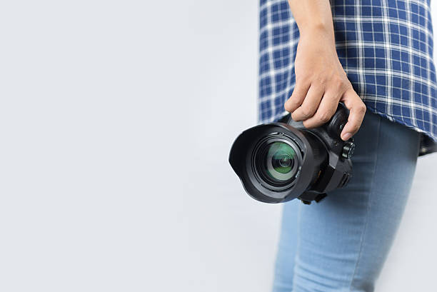 istock photographer holding his camera 612389060