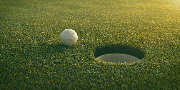 Golf ball rolling towards hole Golf ball rolling towards hole rolling field stock pictures, royalty-free photos & images