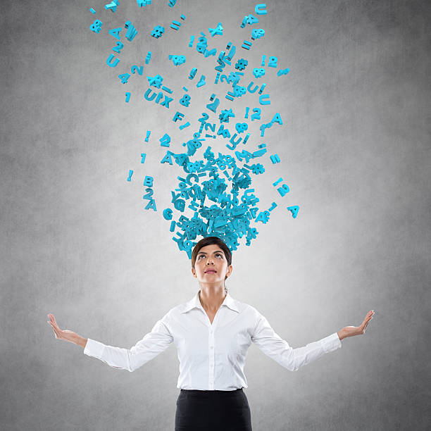 istock Alphabet emerging from businesswoman's head 612390454