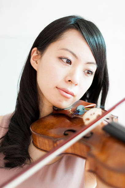 istock Japanese woman playing a violin 612391498