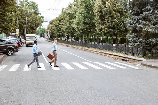 istock two businessmen  crossing the road 612391796