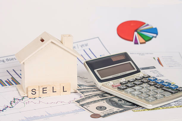 istock Miniature house with money and chart 612392092