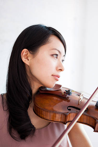 istock Japanese woman playing a violin 612392252