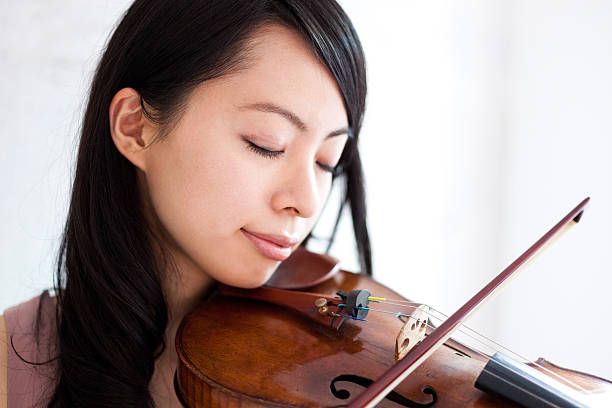 istock Japanese woman playing a violin 612392288