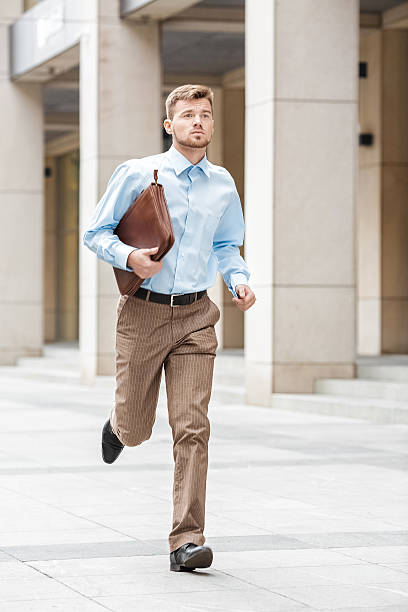 istock businessman with  briefcase running 612392348