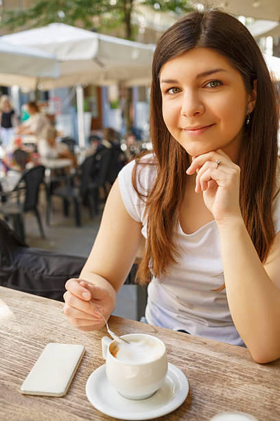 istock Cappuccino Capo  Young women drinking coffee in a cafe 612392526