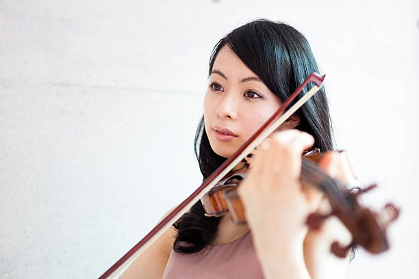 istock Japanese woman playing a violin 612392594