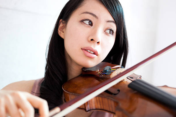 istock Japanese woman playing a violin 612392970