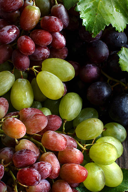 istock Three types of grapes on a wooden Background 612393862