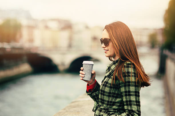 istock Young woman drinking coffee in Paris 612396504